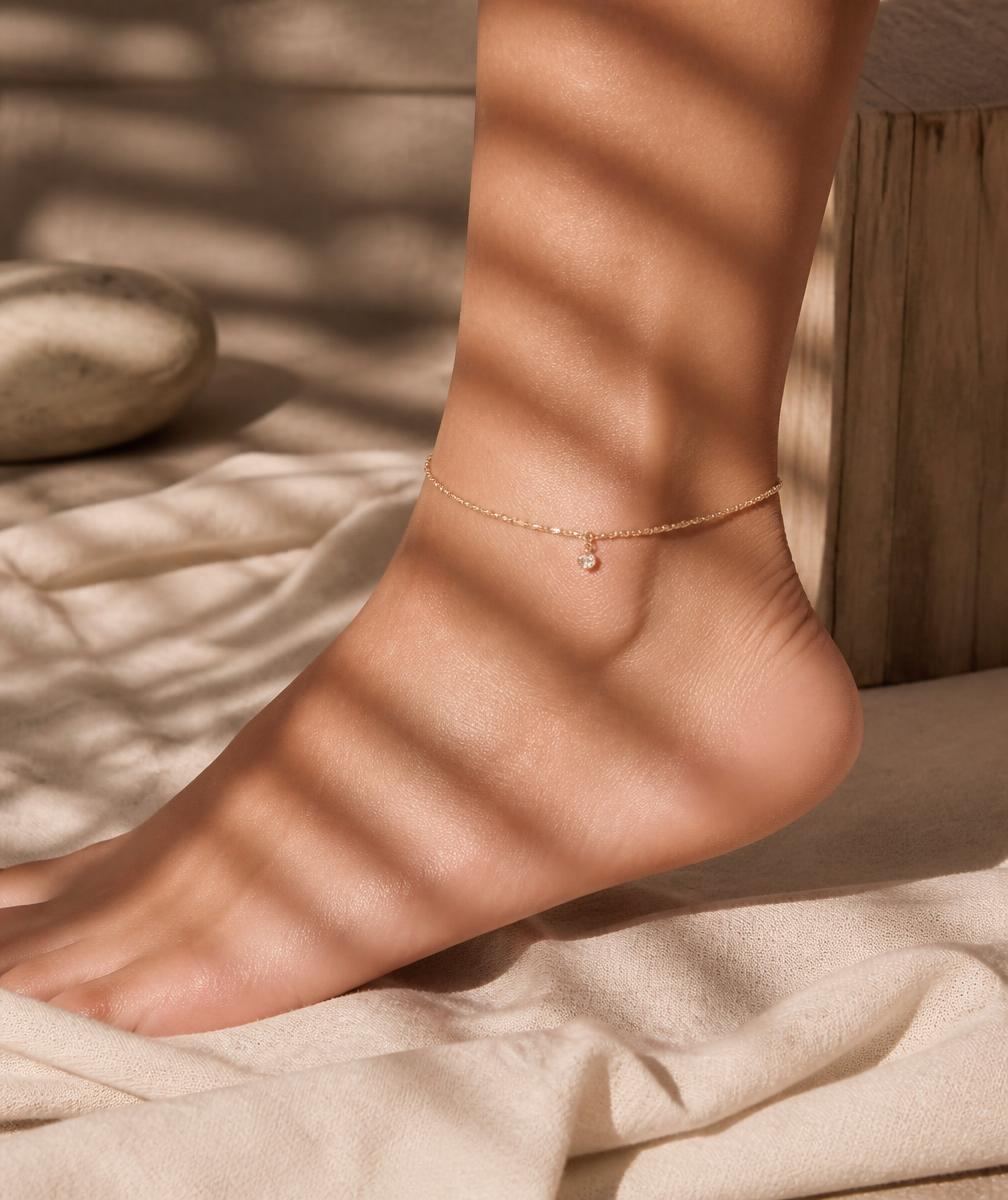 Gold chain anklet in afternoon light